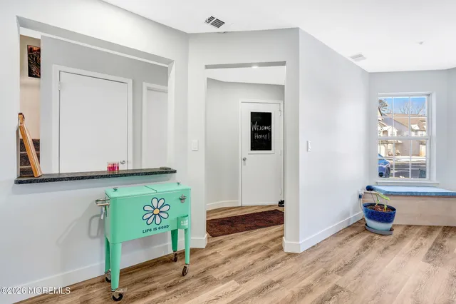 a view of an entryway with wooden floor
