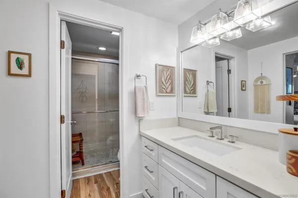 a bathroom with a sink double vanity and a shower