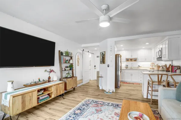 a kitchen with granite countertop white cabinets and stainless steel appliances