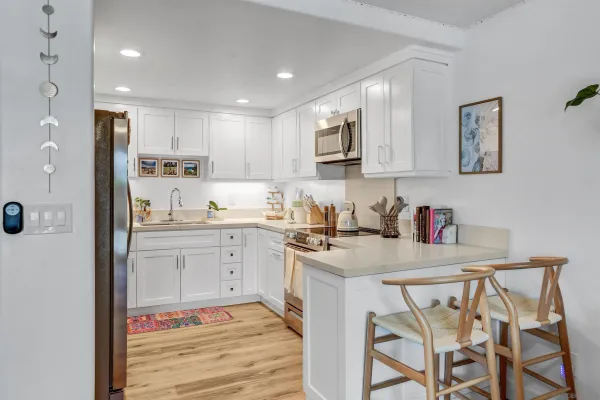 a kitchen with stainless steel appliances granite countertop a stove a sink and a refrigerator