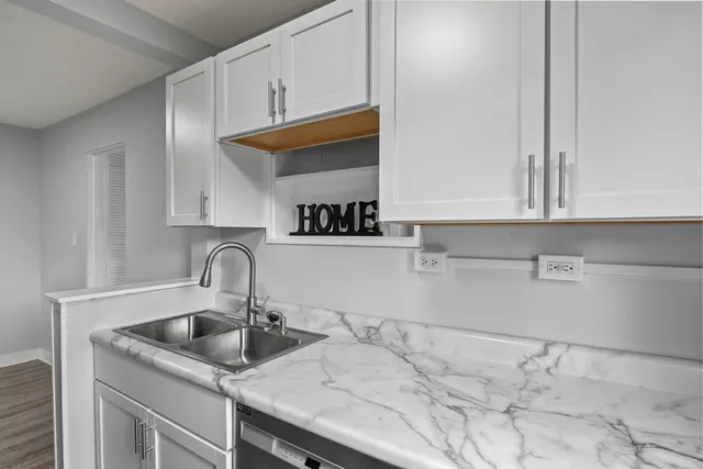 a kitchen with stainless steel appliances granite countertop a sink and cabinets