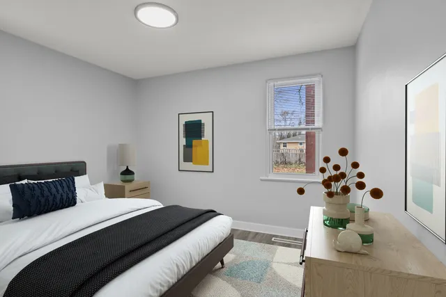 a bedroom with a bed and a potted plant