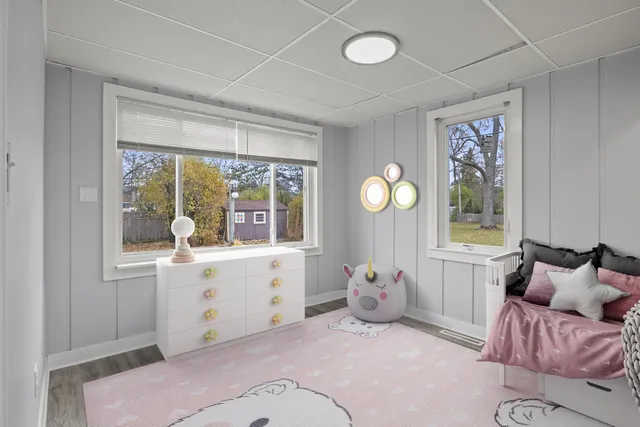 a bedroom with furniture and a large window