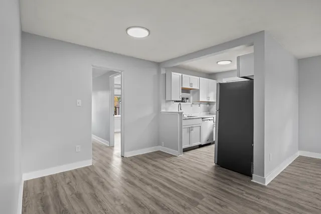 a view of a kitchen with wooden floor