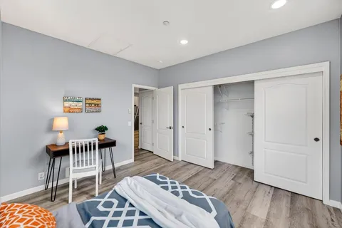 a bedroom with furniture and a window