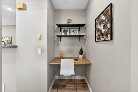 a view of a hallway with seating area