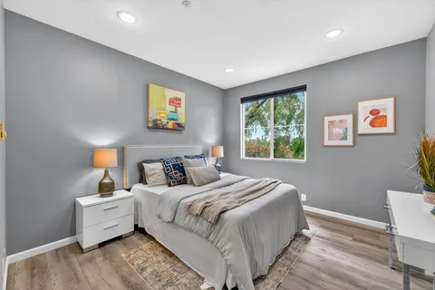 a spacious bedroom with a bed and a window