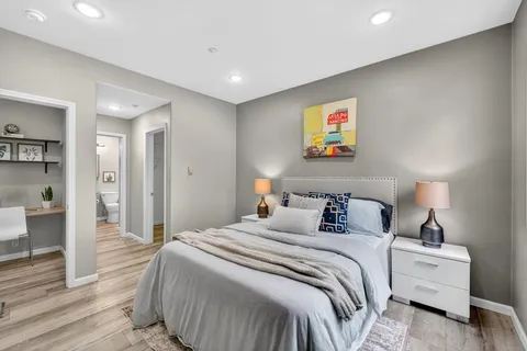 a bedroom with bed and a night stand