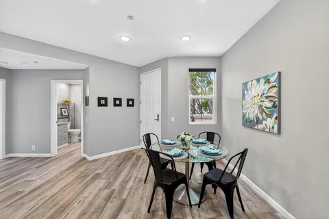 a view of a dining room with furniture and window