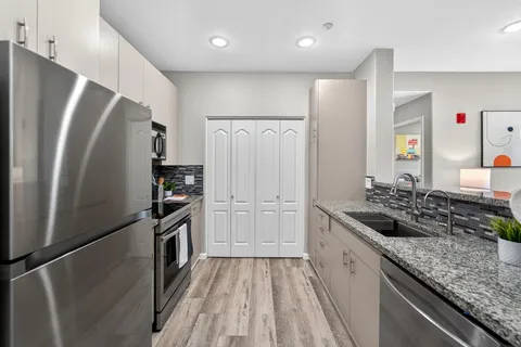 a kitchen with a refrigerator and a sink