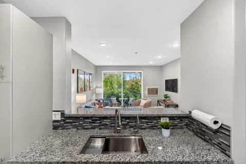 a kitchen with a sink a window and a counter top space