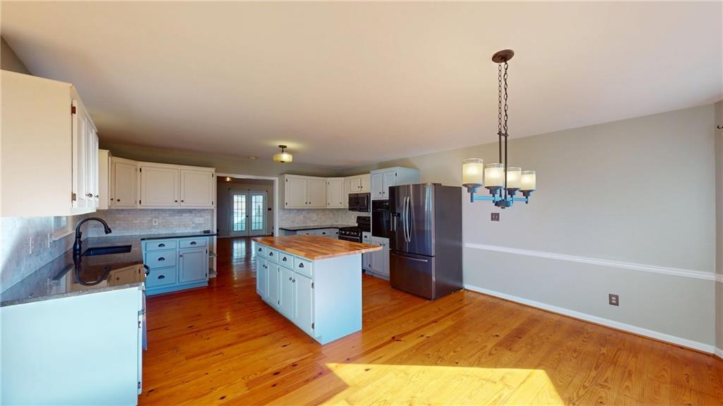 1042 Mission Road Southwest Cartersville, GA 30120 - Photo 12 of 40 a open kitchen with a refrigerator sink and stove