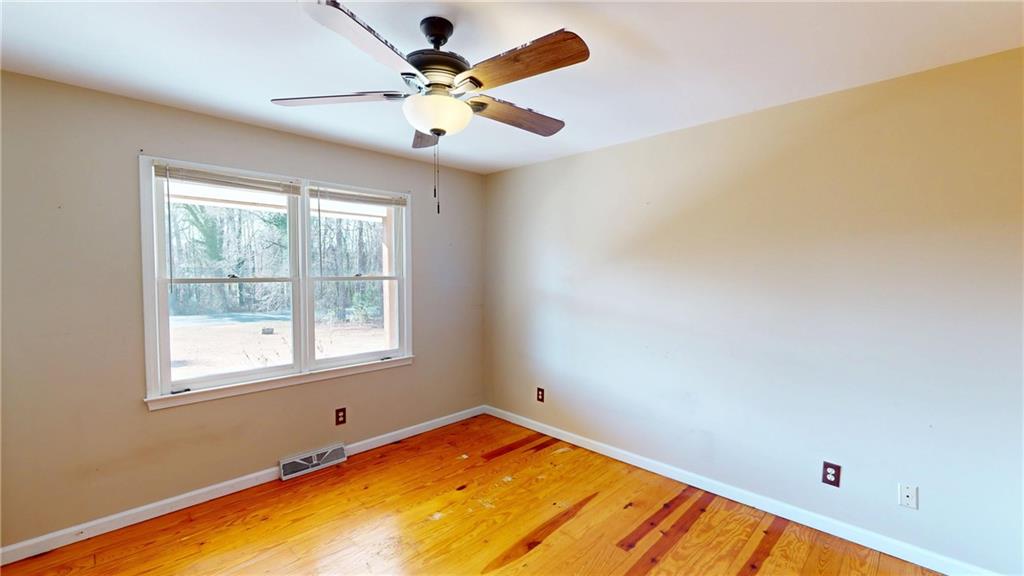 1042 Mission Road Southwest Cartersville, GA 30120 - Photo 16 of 40 a view of a room with a ceiling fan and a window