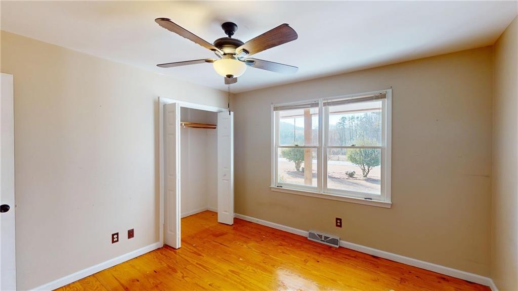 1042 Mission Road Southwest Cartersville, GA 30120 - Photo 17 of 40 a view of a livingroom with a ceiling fan and a window