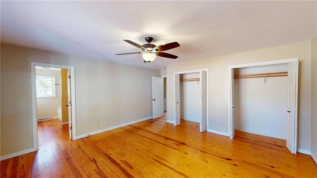1042 Mission Road Southwest Cartersville, GA 30120 - Photo 19 of 40 a bedroom with a bed and a ceiling fan