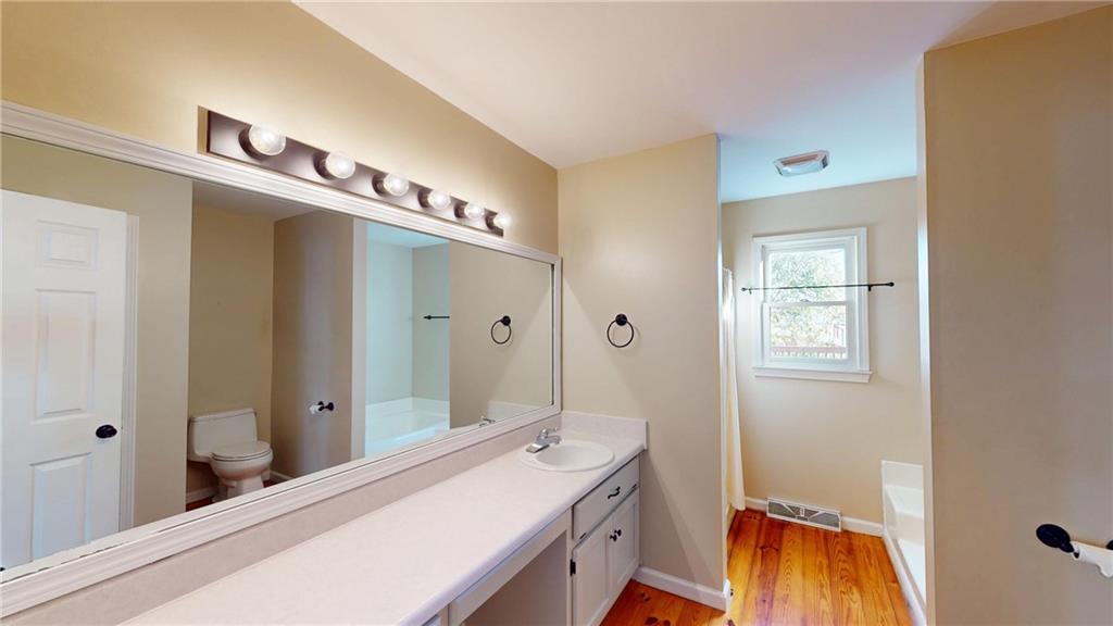 1042 Mission Road Southwest Cartersville, GA 30120 - Photo 20 of 40 a bathroom with a sink and a mirror