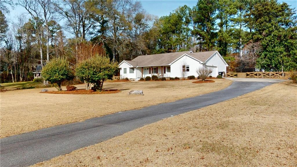 1042 Mission Road Southwest Cartersville, GA 30120 - Photo 2 of 40 a view of a house with a yard and large trees