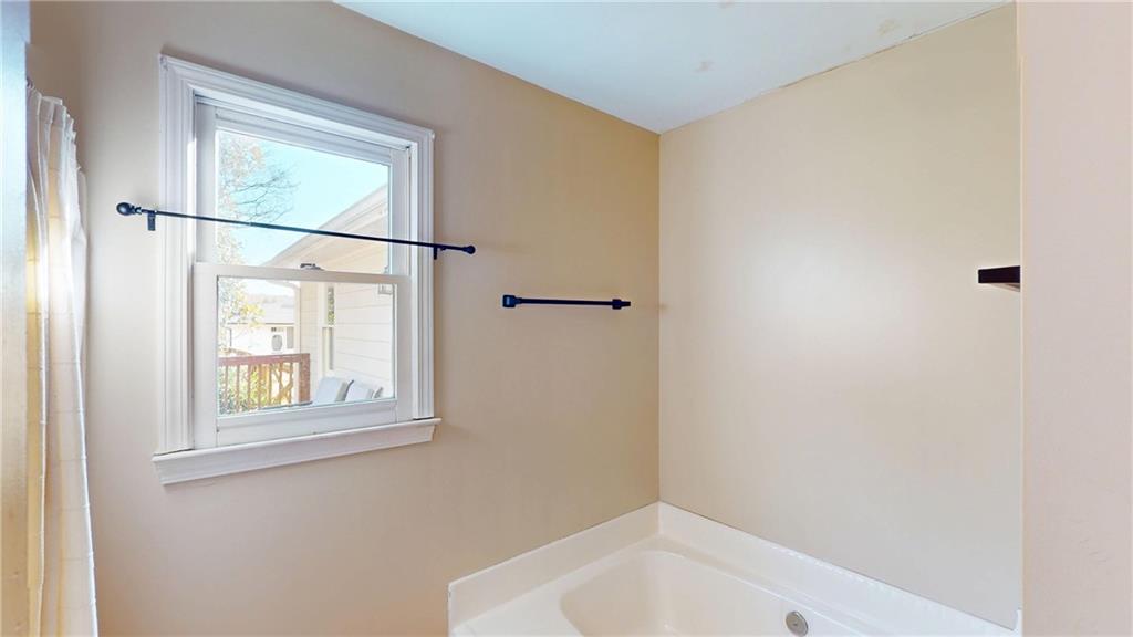 1042 Mission Road Southwest Cartersville, GA 30120 - Photo 22 of 40 a bathroom with a bathtub