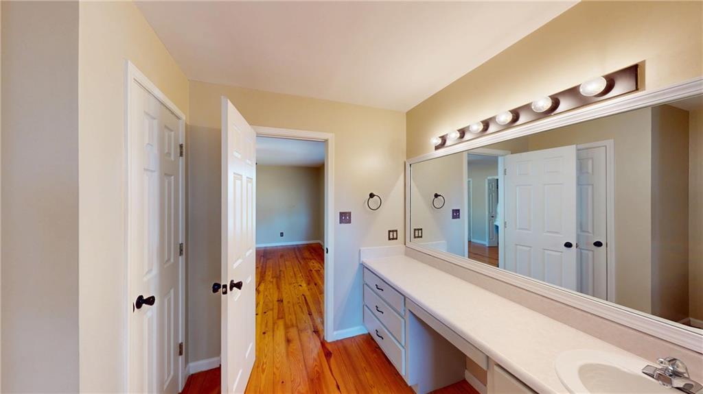 1042 Mission Road Southwest Cartersville, GA 30120 - Photo 24 of 40 a spacious bathroom with a double vanity sink and a mirror