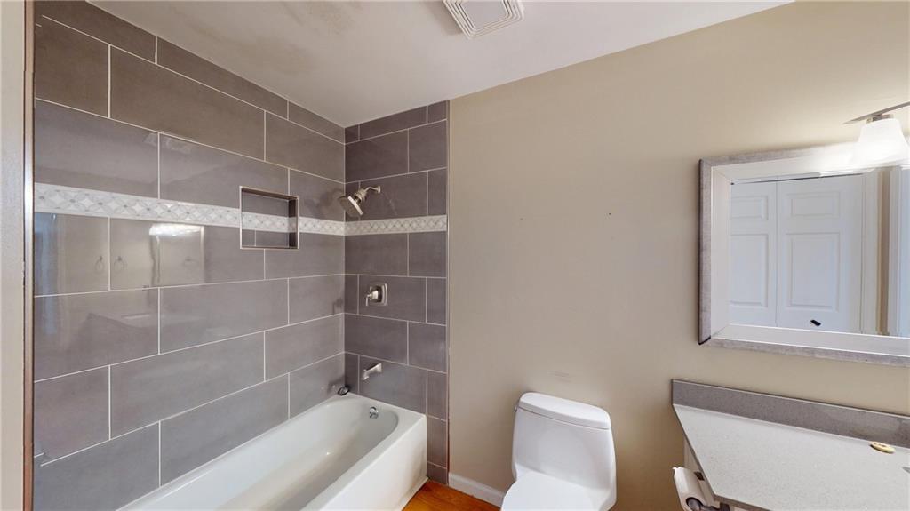 1042 Mission Road Southwest Cartersville, GA 30120 - Photo 26 of 40 a bathroom with a toilet and a bathtub