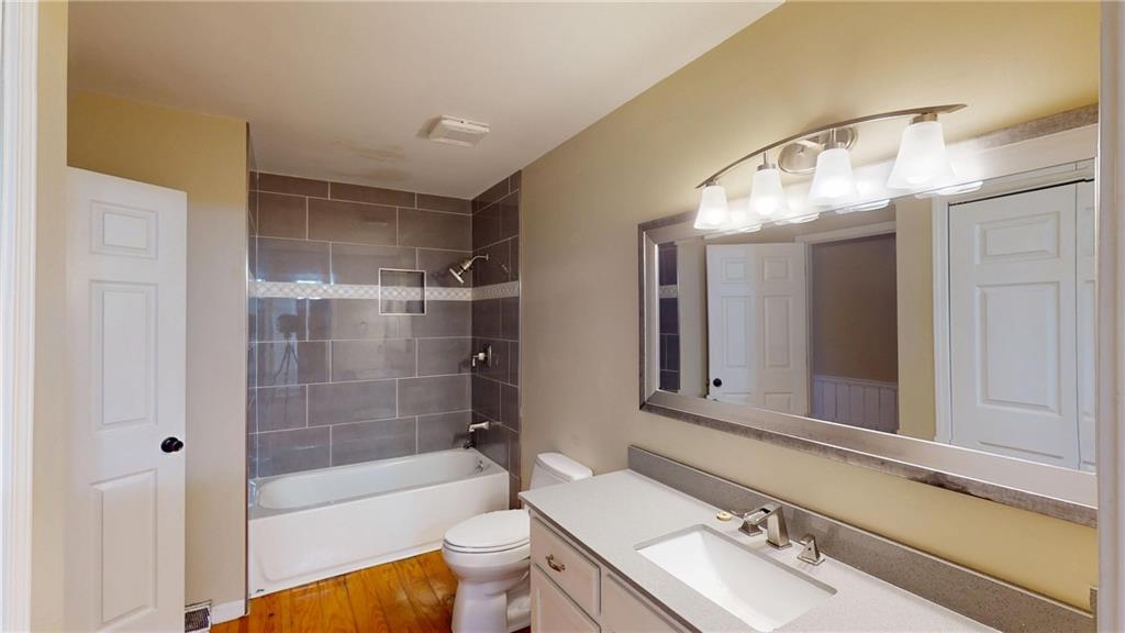 1042 Mission Road Southwest Cartersville, GA 30120 - Photo 29 of 40 a bathroom with a sink mirror toilet and bathtub