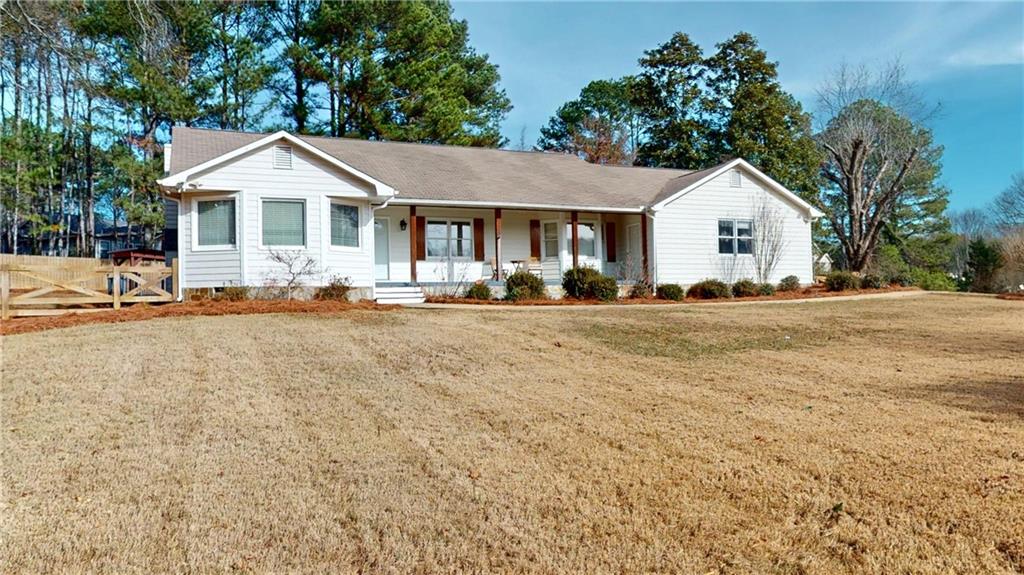 1042 Mission Road Southwest Cartersville, GA 30120 - Photo 3 of 40 a front view of a house with a yard