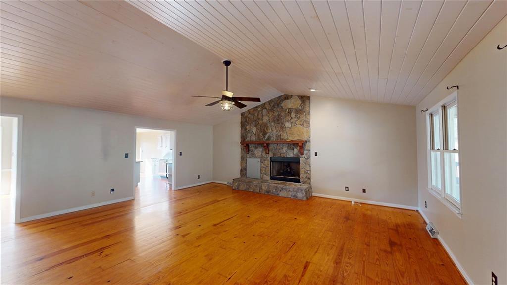 1042 Mission Road Southwest Cartersville, GA 30120 - Photo 7 of 40 a view of empty room with a fireplace and wooden floor