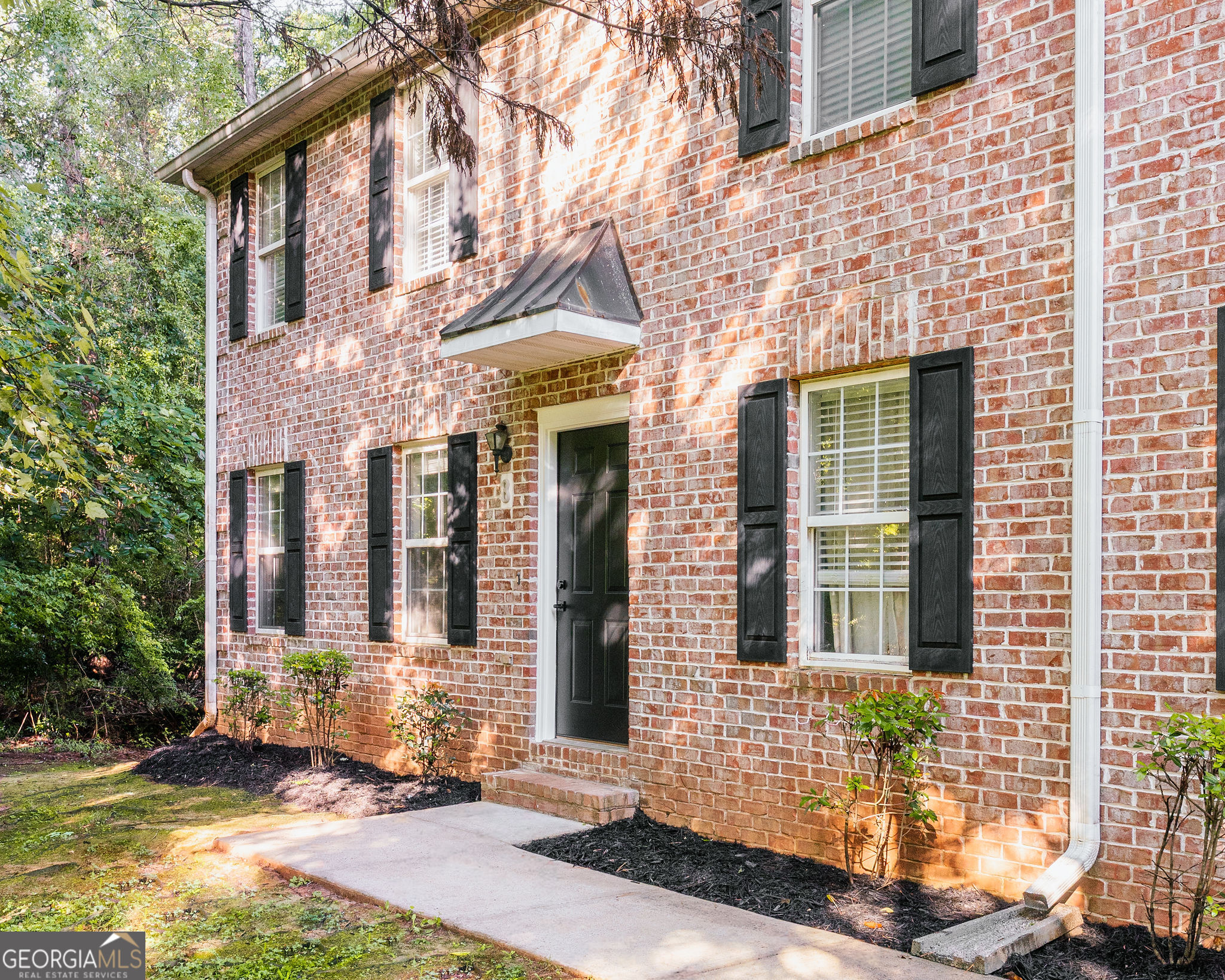 front view of a brick house with a large windows