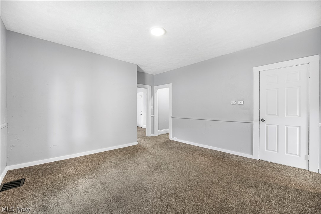 885 Wales Road Northeast Massillon, OH 44646 - Photo 24 of 34 Neutral-toned carpeting and light gray walls define this room, featuring white baseboards and door trim