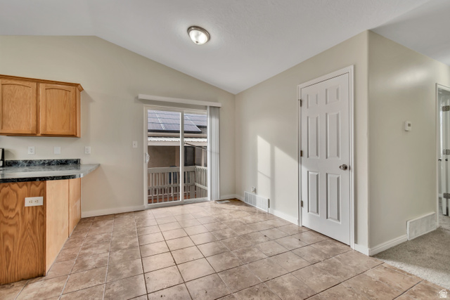 1118 North Ridge Court Spanish Fork, UT 84660 - Photo 12 of 32 Unfurnished dining area with lofted ceiling and light tile patterned floors