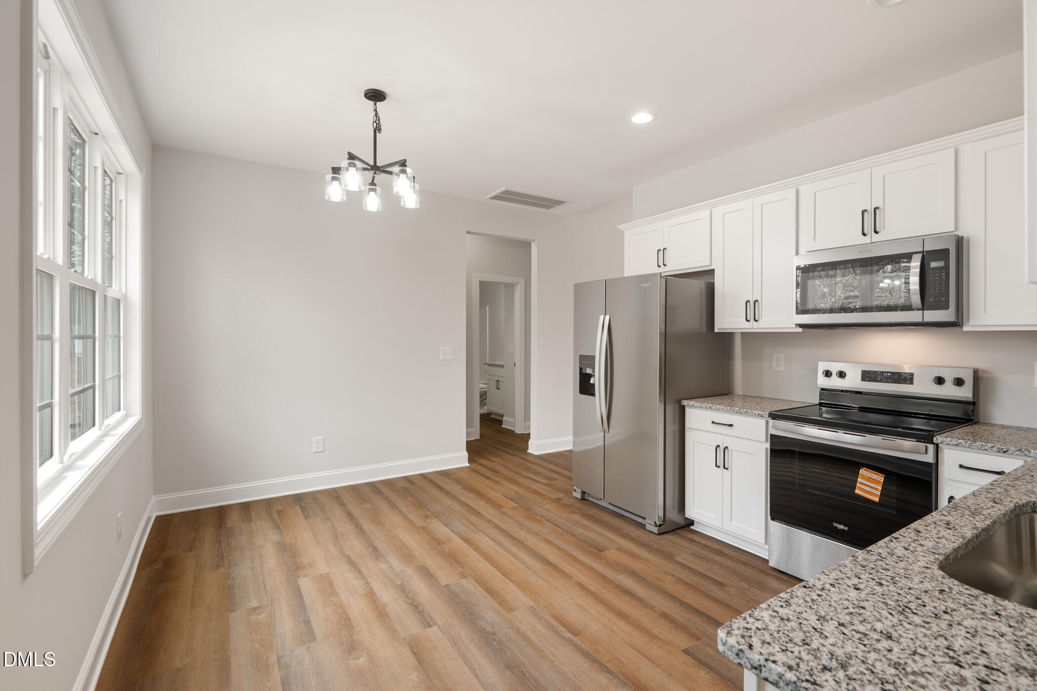 374 Vicksboro Road Henderson, NC 27536 - Photo 10 of 23 a kitchen with stainless steel appliances granite countertop a refrigerator a stove top oven a sink dishwasher and a refrigerator with wooden floor