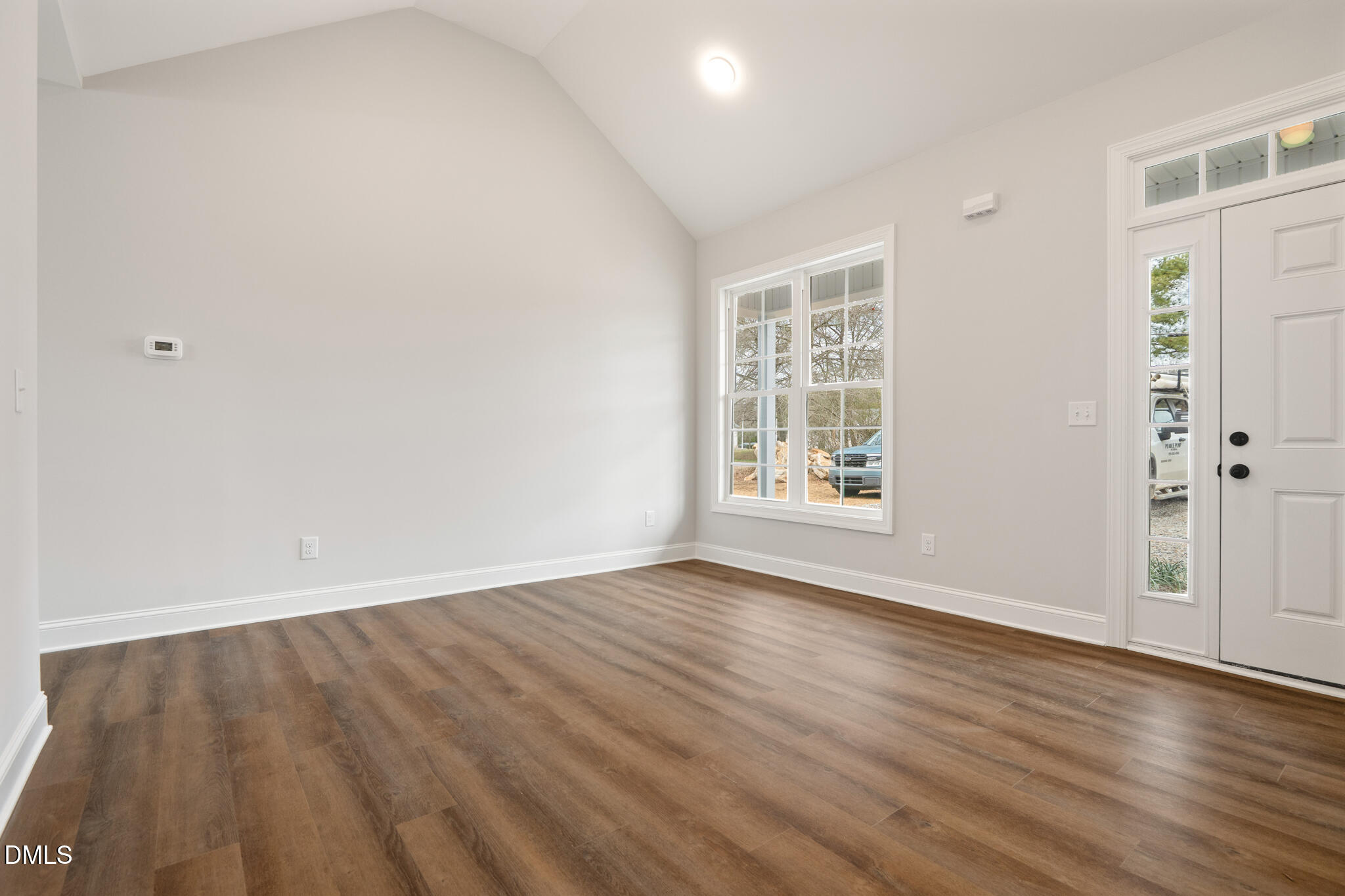 374 Vicksboro Road Henderson, NC 27536 - Photo 6 of 23 wooden floor in an empty room with a window