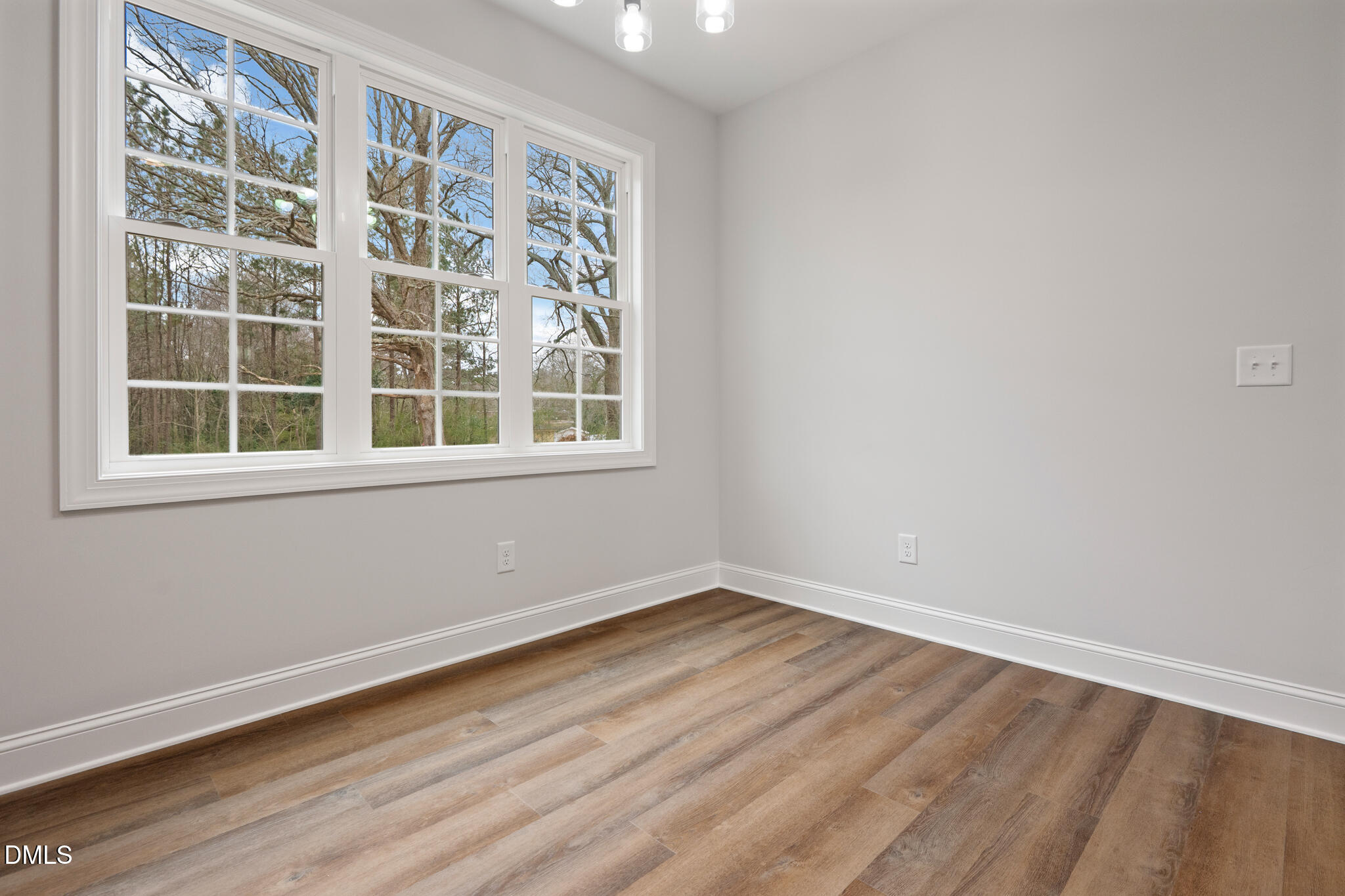 374 Vicksboro Road Henderson, NC 27536 - Photo 7 of 23 a view of empty room with wooden floor and fan