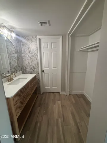 a bed sitting in a room next to a window