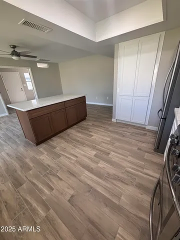 a view of an empty room with wooden floor