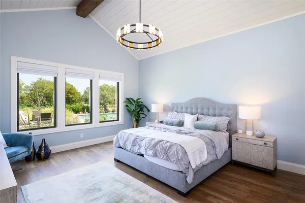 a bedroom with a large bed and a desk