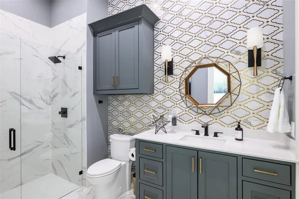 a bathroom with a sink mirror vanity and toilet