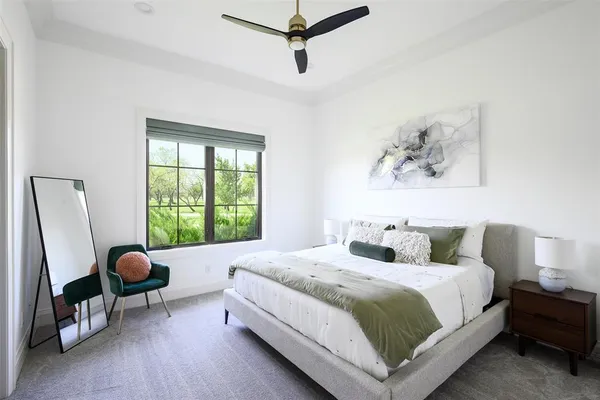 a bedroom with a bed a couch and a window