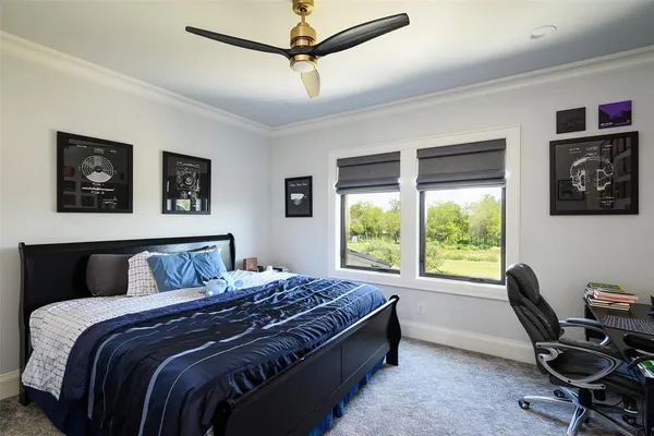 a bedroom with a large bed and a desk