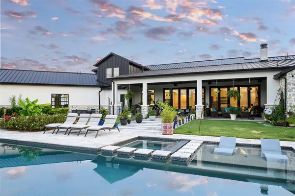 a view of a house with backyard sitting area and garden
