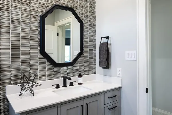 a bathroom with a sink vanity and mirror