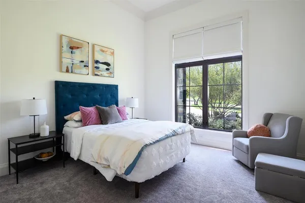 a bedroom with a bed and a couch next to a window