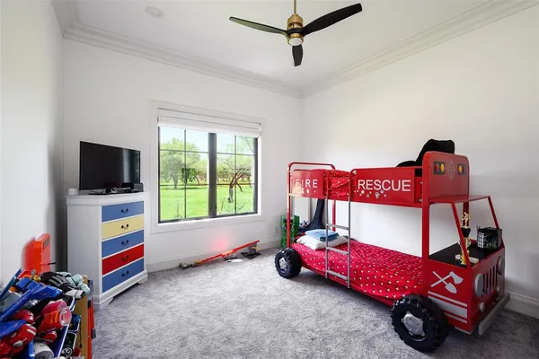 a bedroom with furniture and a flat screen tv