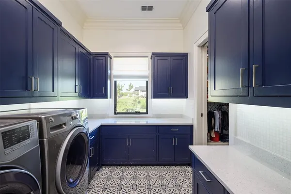 a utility room with sink dryer and washer