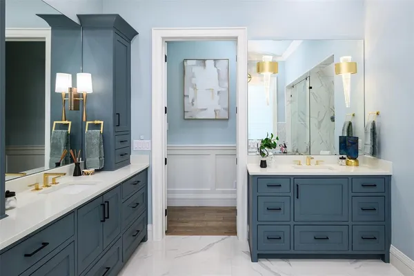 a bathroom with a double vanity sink and a mirror
