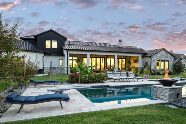 a swimming pool view with a seating space and a garden