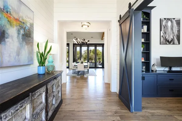 a living room with furniture a flat screen tv and a floor to ceiling window