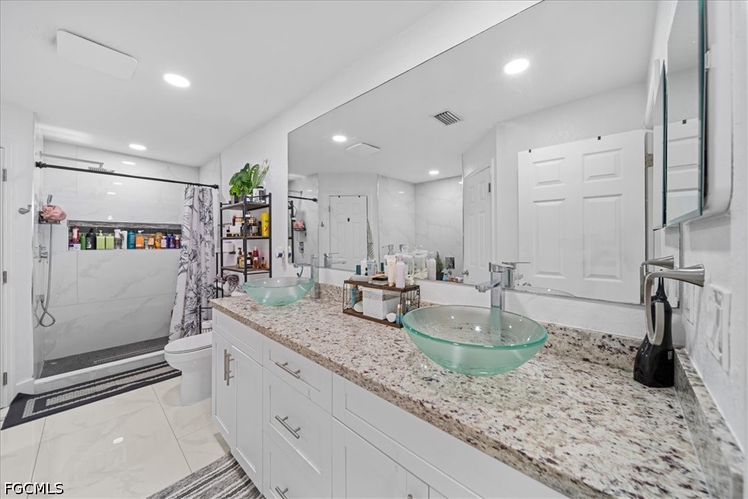 22 Nelson Road South Cape Coral, FL 33991 - Photo 28 of 43 a bathroom with a granite countertop sink and a mirror