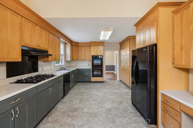 a kitchen with stainless steel appliances granite countertop a refrigerator stove and oven