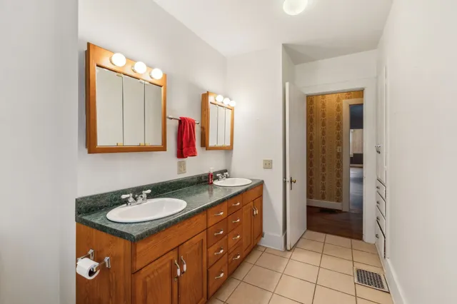 a bathroom with a sink vanity and mirror